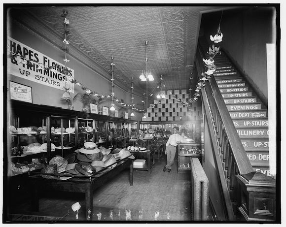 A photograph, possibly taken by the gas company, shows off the light fixtures in a Detroit millinery store.